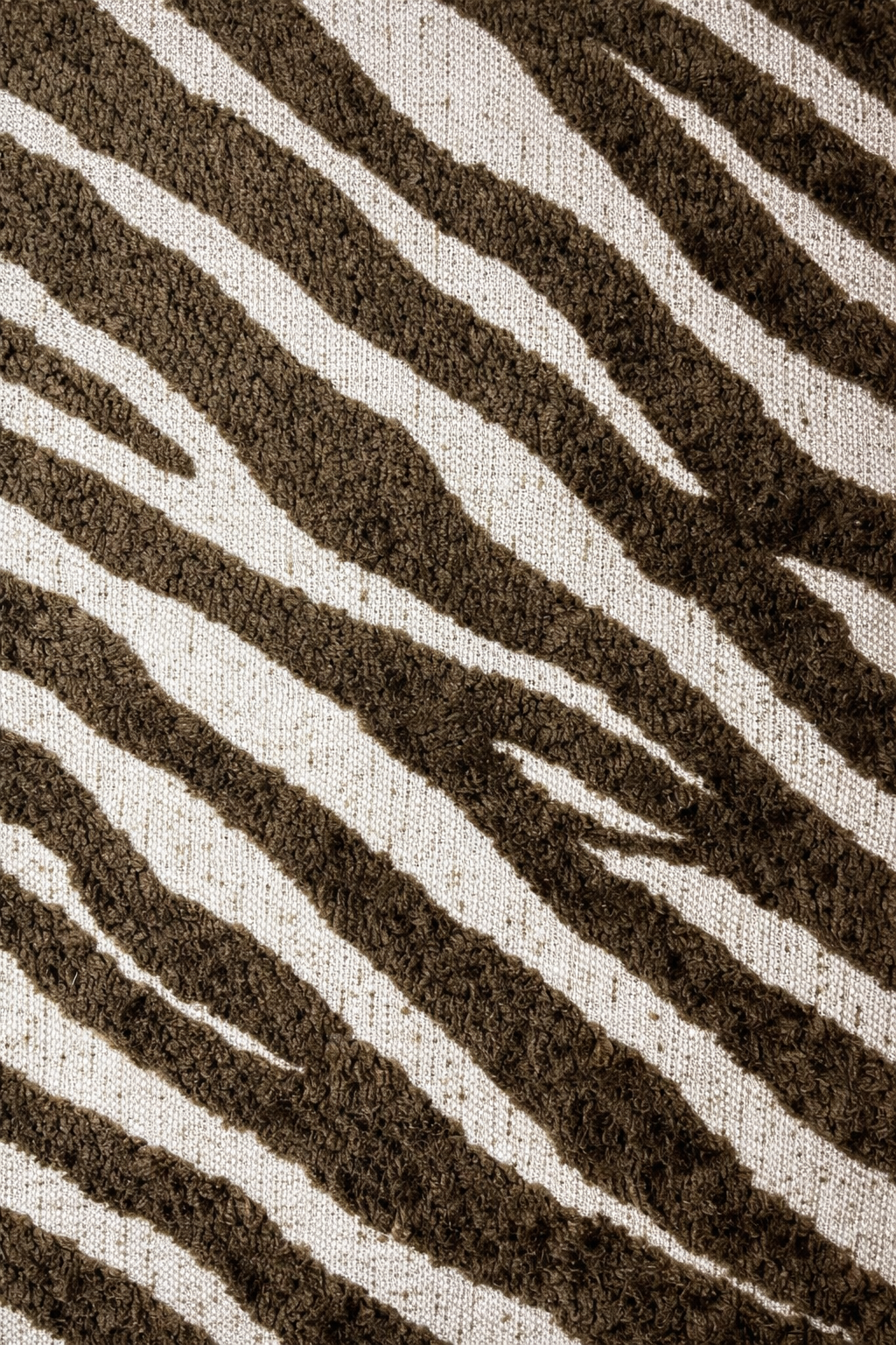 Close-up of a brown and white zebra-striped pattern cushion
