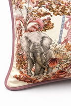 Square blush pink and cream velvet cushion cover with botanical and animal print, featuring elephants, swans and a tiger, finished with dusty pink piping.