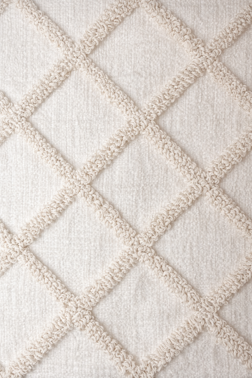 Beige rectangular cushion with diamond tufted detailing and tassel corners