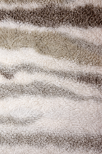 Beige faux shearling cushion with soft striped texture