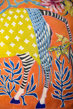 Orange velvet cushion cover with illustrated zebra, floral motifs and blue tassels, square decorative cushion.