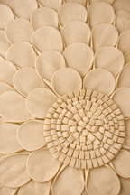 Beige velvet square cushion cover with layered floral appliqué texture and sculpted petal detailing.