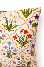 Cream square cushion with multicolour botanical flowers in a repeating trellis lattice pattern