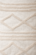 Beige square cushion with raised diamond tufted bands and tassel corners