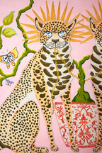 Pink velvet cushion cover with two illustrated cheetahs, sunburst halos, birds, floral branches and brown tassel corners