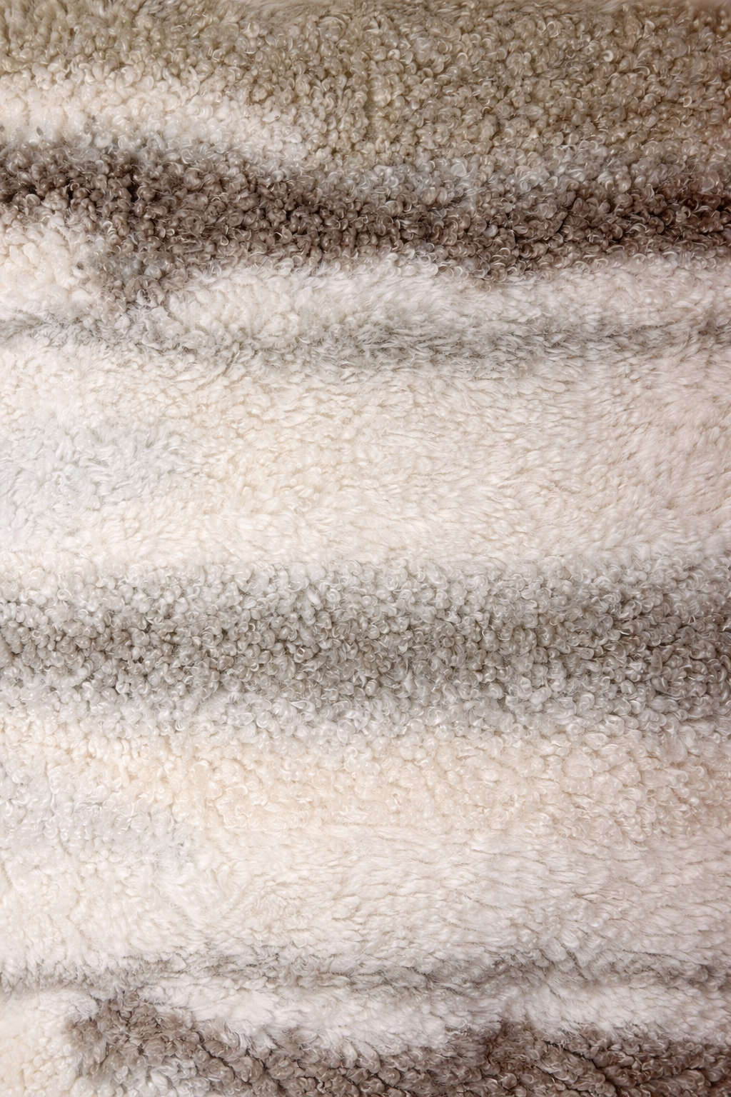 Beige faux shearling cushion with soft striped texture