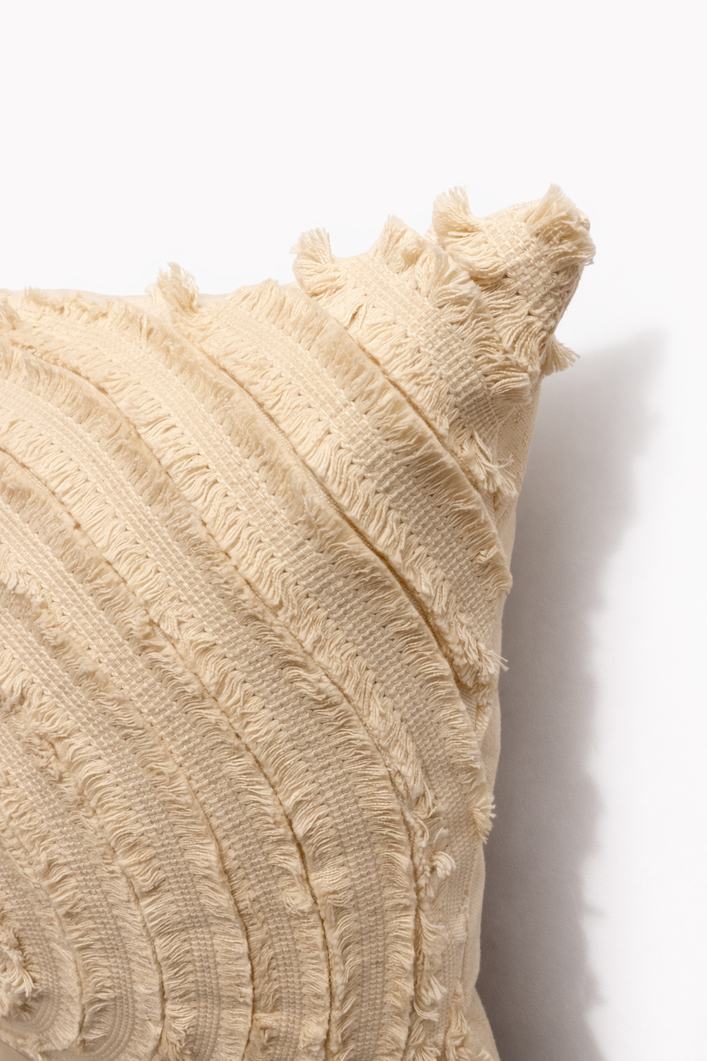 Ivory square cushion with concentric circular design appliqué and layered stitched pattern