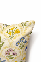 Cream square cushion with multicolour botanical flowers in a repeating scallop pattern