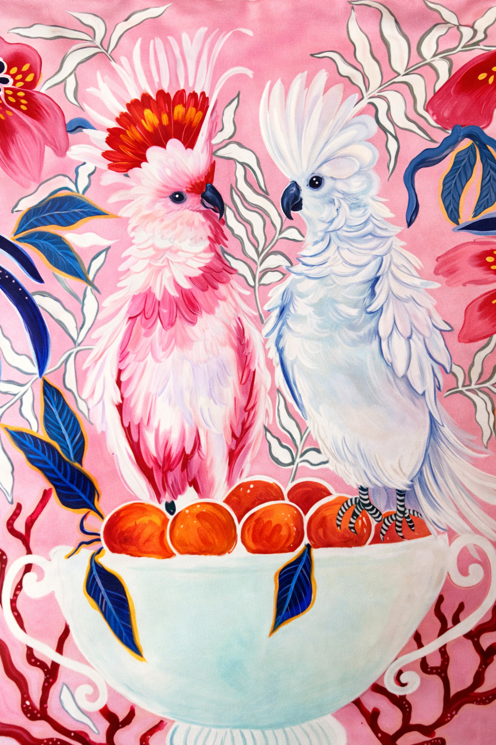 Square pink velvet cushion cover featuring illustrated cockatoos, floral motifs and red tassel corners