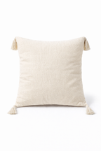 Beige square cushion with tufted geometric patterns and tassel corners