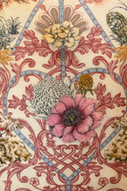 Square blush pink and cream velvet cushion cover with botanical and animal print, featuring elephants, swans and a tiger, finished with dusty pink piping.