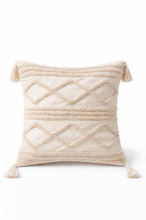 Beige square cushion with raised diamond tufted bands and tassel corners
