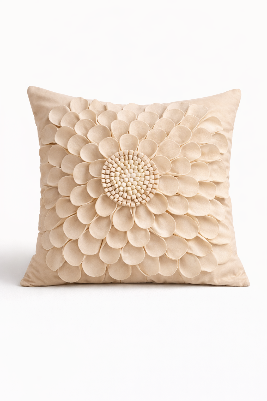 Beige velvet square cushion cover with layered floral appliqué texture and sculpted petal detailing.