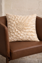 Beige velvet square cushion cover with layered floral appliqué texture and sculpted petal detailing.