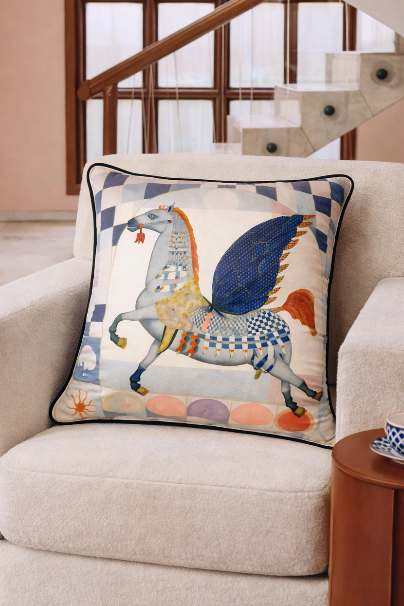 Blue and cream velvet cushion cover featuring a winged horse illustration with navy wings and pastel detailing, square cushion