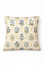Cream square cushion with blue floral motifs and repeating arched lattice pattern