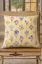 Cream square cushion with multicolour botanical flowers in a repeating scallop pattern