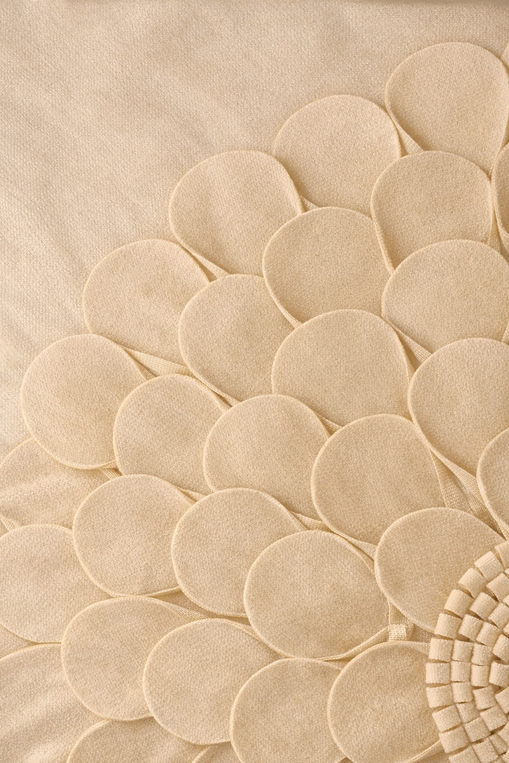 Beige velvet square cushion cover with layered floral appliqué texture and sculpted petal detailing.