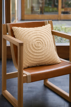 Ivory square cushion with concentric circular design appliqué and layered stitched pattern