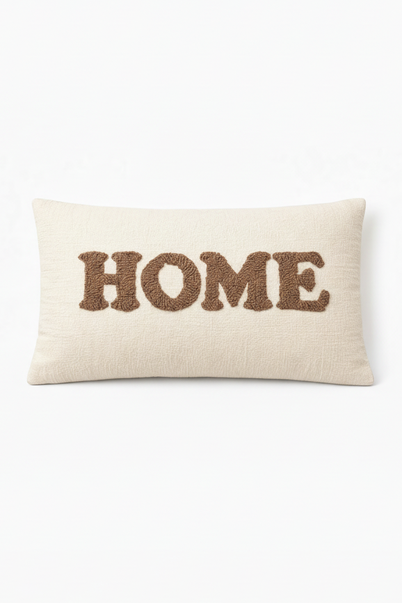 Ivory rectangular cushion with HOME appliqué lettering in raised stitched design