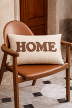Ivory rectangular cushion with HOME appliqué lettering in raised stitched design