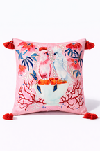 Square pink velvet cushion cover featuring illustrated cockatoos, floral motifs and red tassel corners