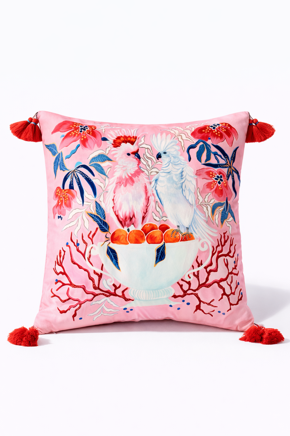 Square pink velvet cushion cover featuring illustrated cockatoos, floral motifs and red tassel corners