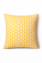 Yellow square cushion with a repeating white leaf botanical motif